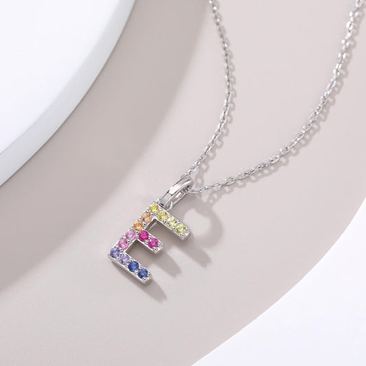 Vibrant lab-grown sapphire "E" pendant | Sterling silver initial necklace